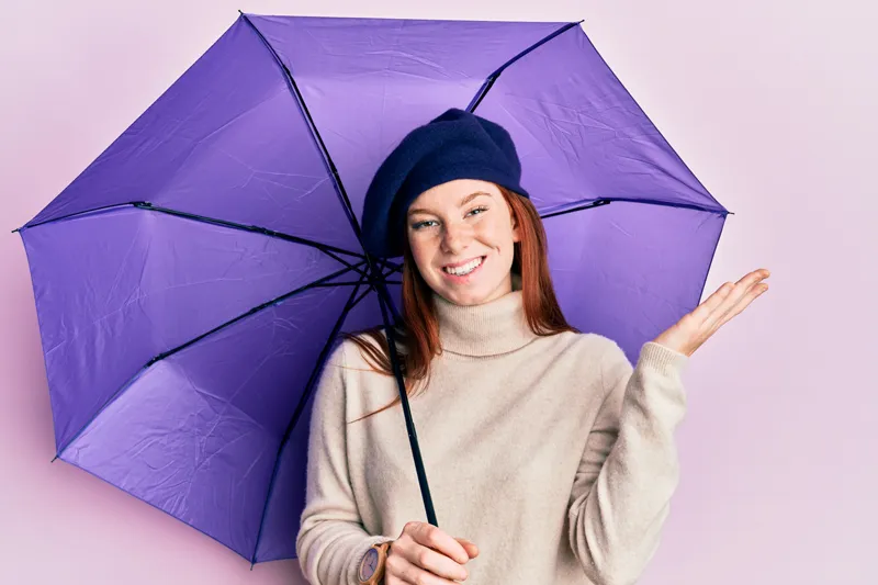 A woman with a branded umbrella from Ignition Marketing