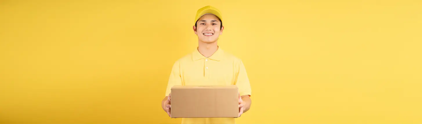 man wearing promotional clothing holding a brandable corporate gift box