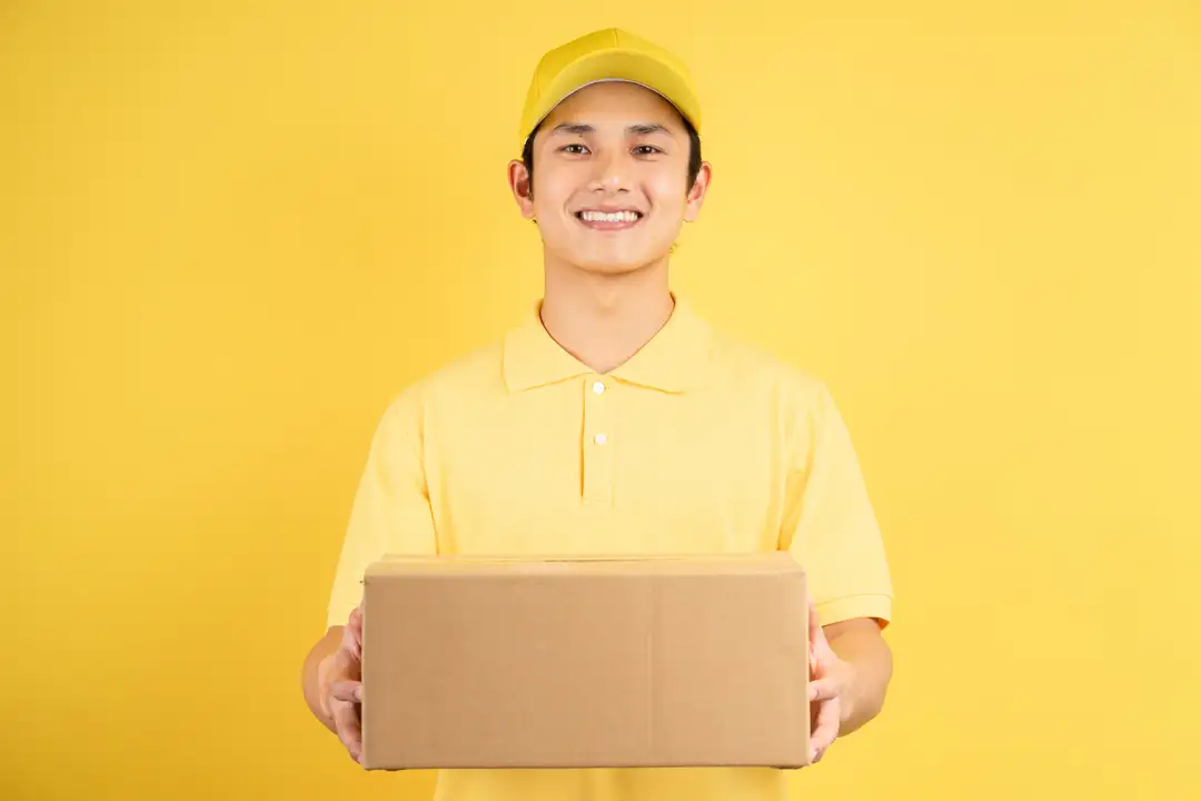 man wearing corporate work uniform  whilst holding a promotional gift box