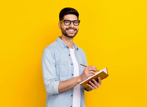a man writing something in is notebook