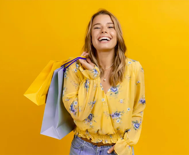 a lady smiling  holding leisure bags