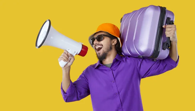 man talking on a magaphone holding a travel suuitcase from Ignition Marketing