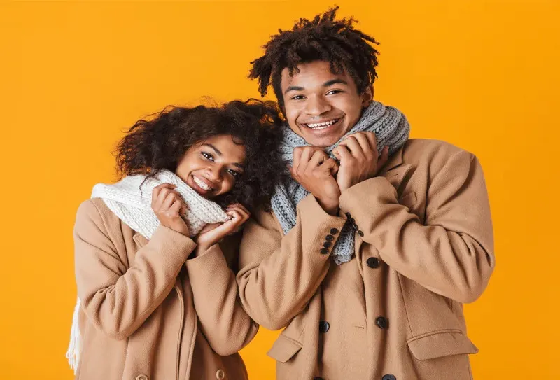 A man and woman wearing winter jackets from Ignition Marketing