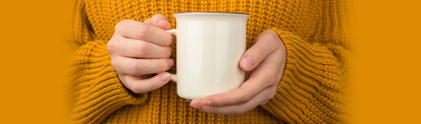 winter picture of a coffee mug being held up