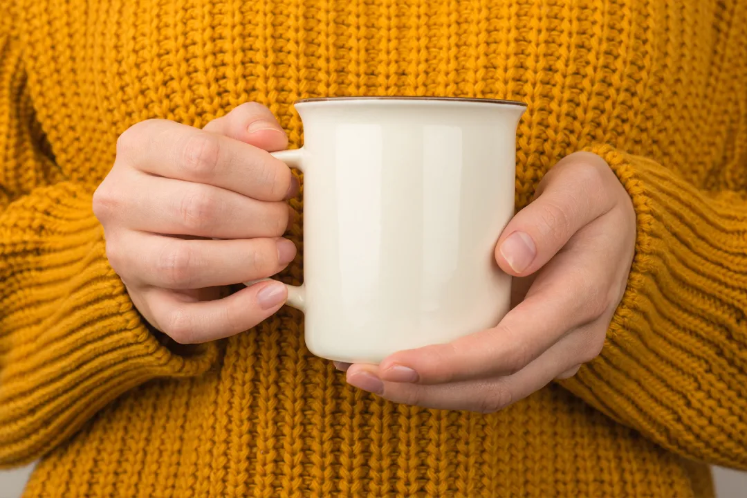 winter picture of a coffee mug being held up