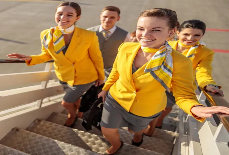 air hostess staff wearing corporate uniform walking together smiling