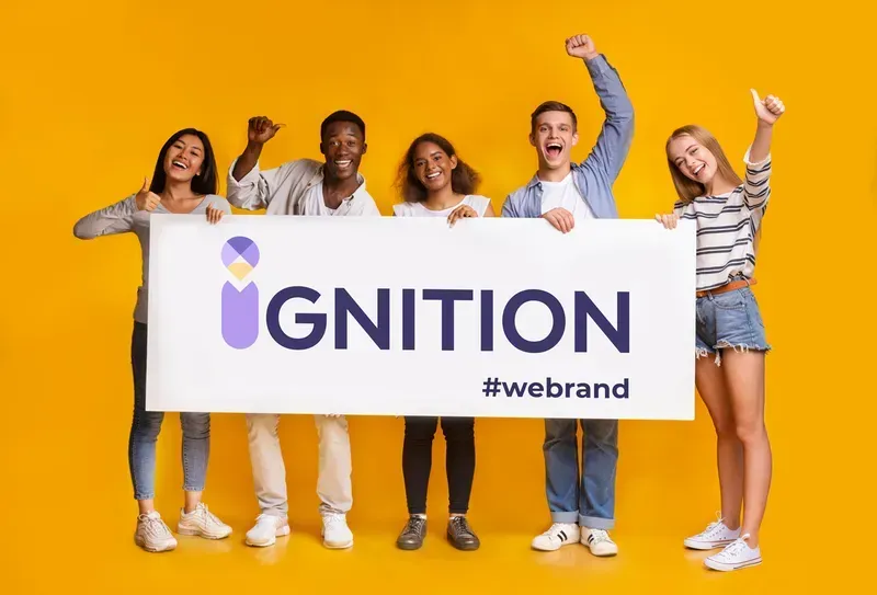 a group of people holding a big sign written Ignition Marketing