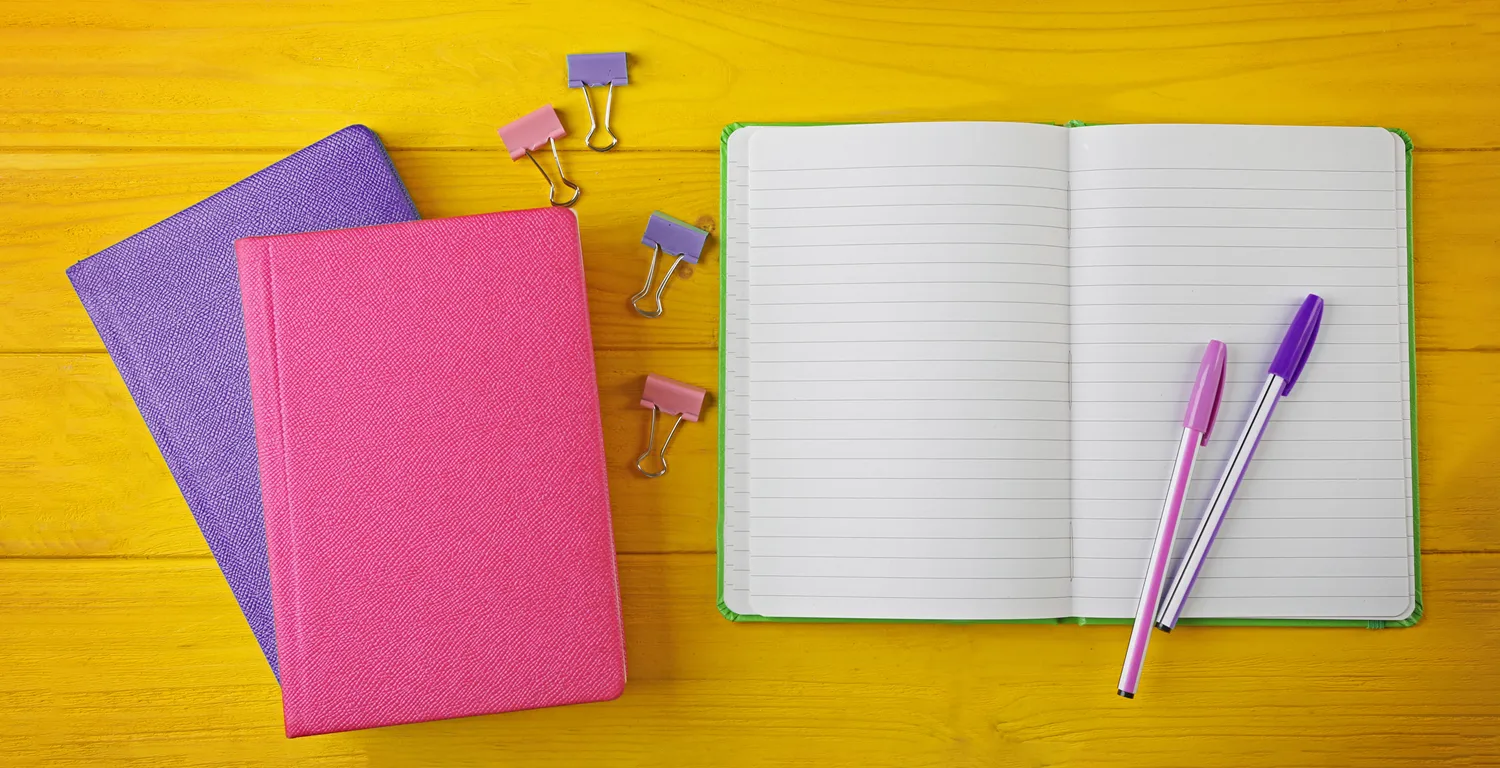 a notebook and a pen in Ignition Marketing colours