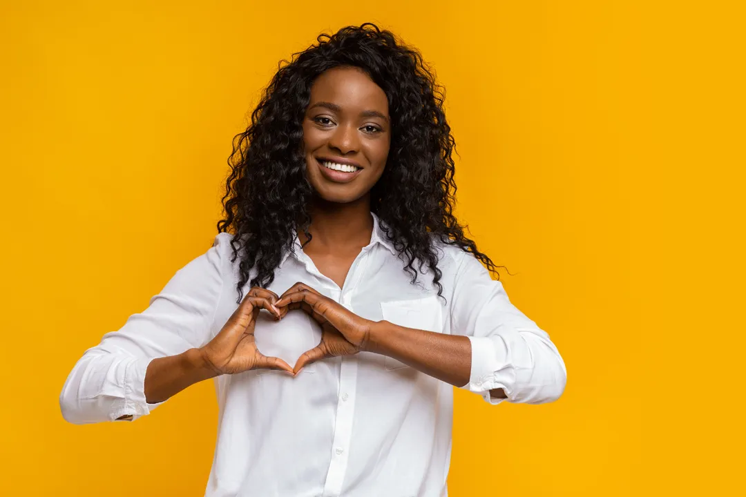 Lady holding up heart sign for personalized gifts - mobile hero image, expressing love to employees and clients