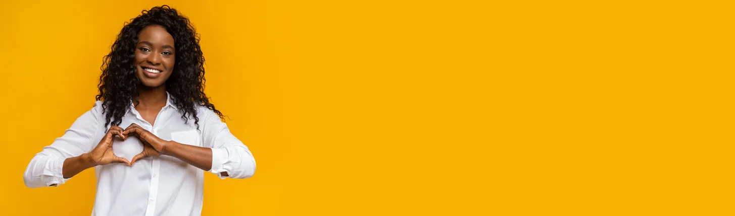 Lady holding up heart sign hero image - perfect for expressing love to employees and clients with personalized gifts