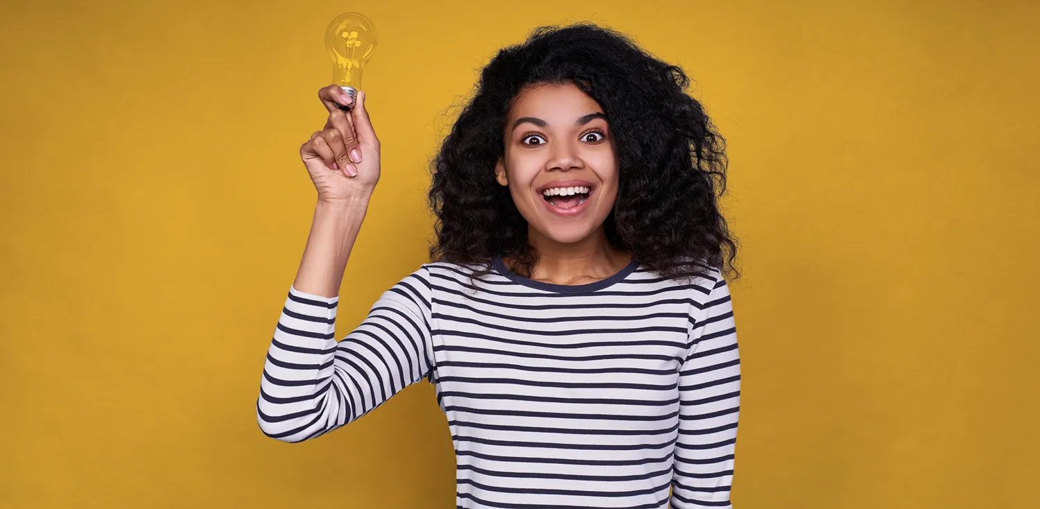 a lady with a light bulb, she has a facial expression of excitement