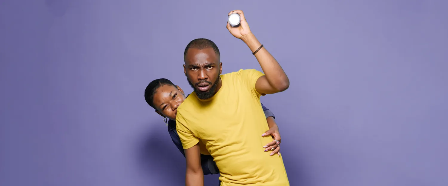 a woman and a man holding a light looking at something ahead of them