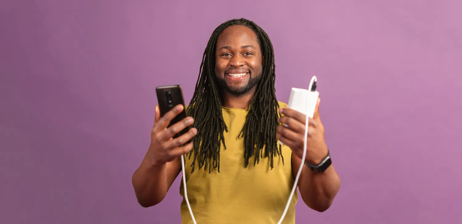 a man holding a phone and personalised power bank which a connected together via a cable