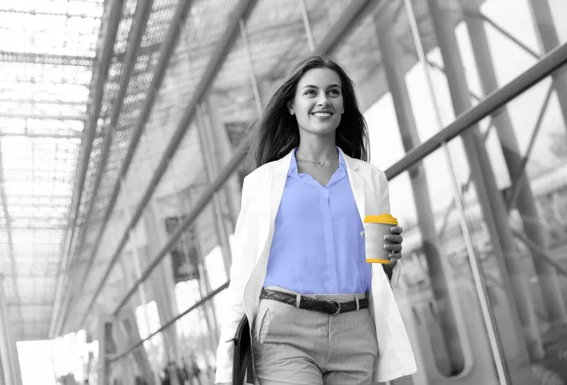 lady wearing a corporate clothing holding a custom branded cup