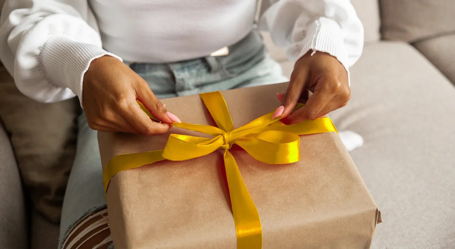Lady wrapping a promotional gift hamper box
