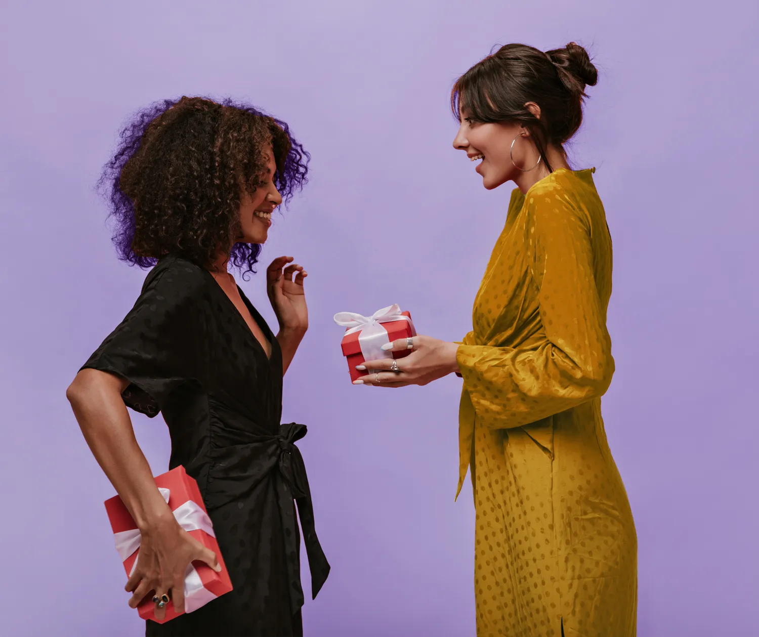 two women gifting each other corporate branded gift boxes