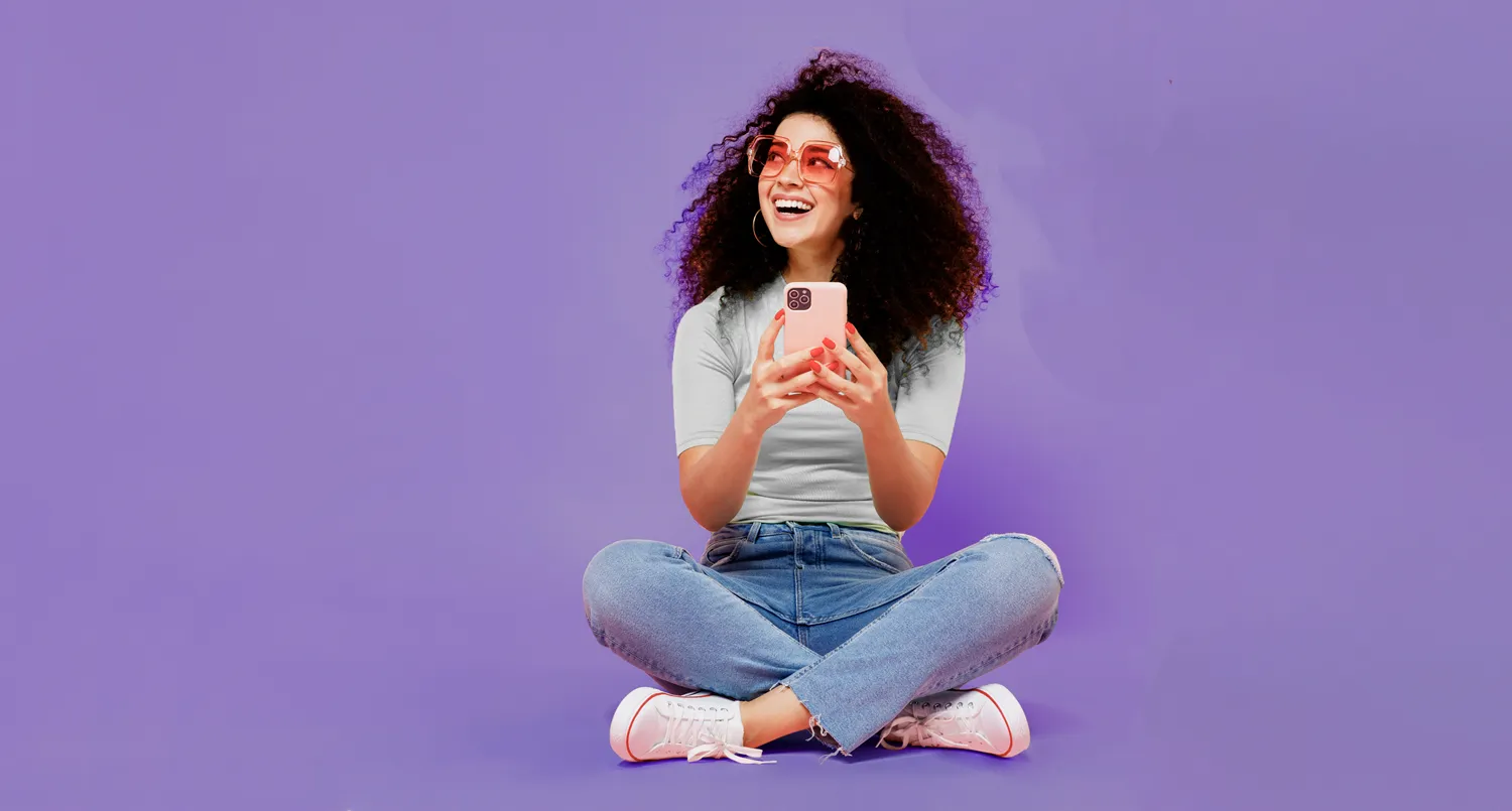 a woman with a phone, sitting down