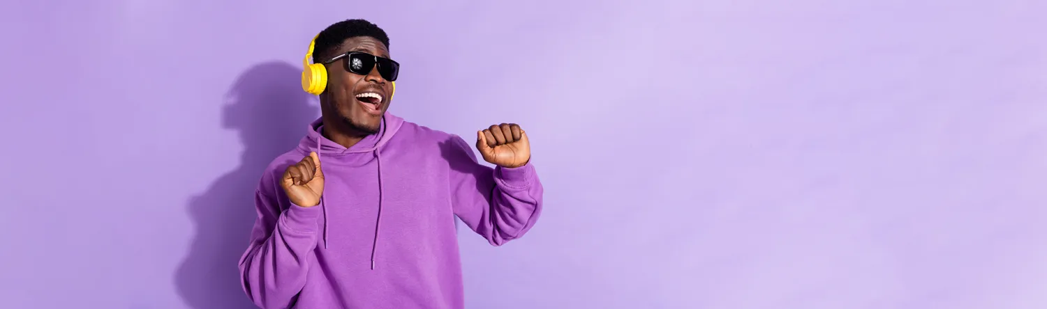 a young man listening to music, with branded headphones